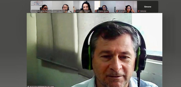 TRE-RR- Curso efeito estufa Imagem mostra uma reunião virtual na plataforma Zoom. Em destaque, um homem de fones de ouvido c...